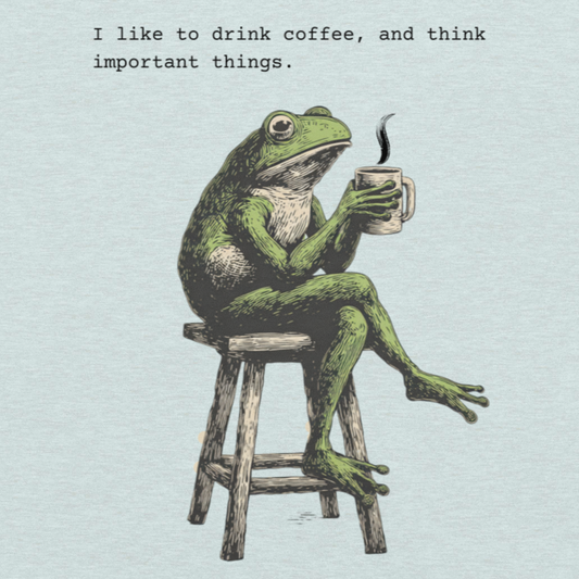 A light blue graphic print featuring a green frog sitting on a wooden stool and holding a mug, with the text 'I like to drink coffee, and think important things.' above it.